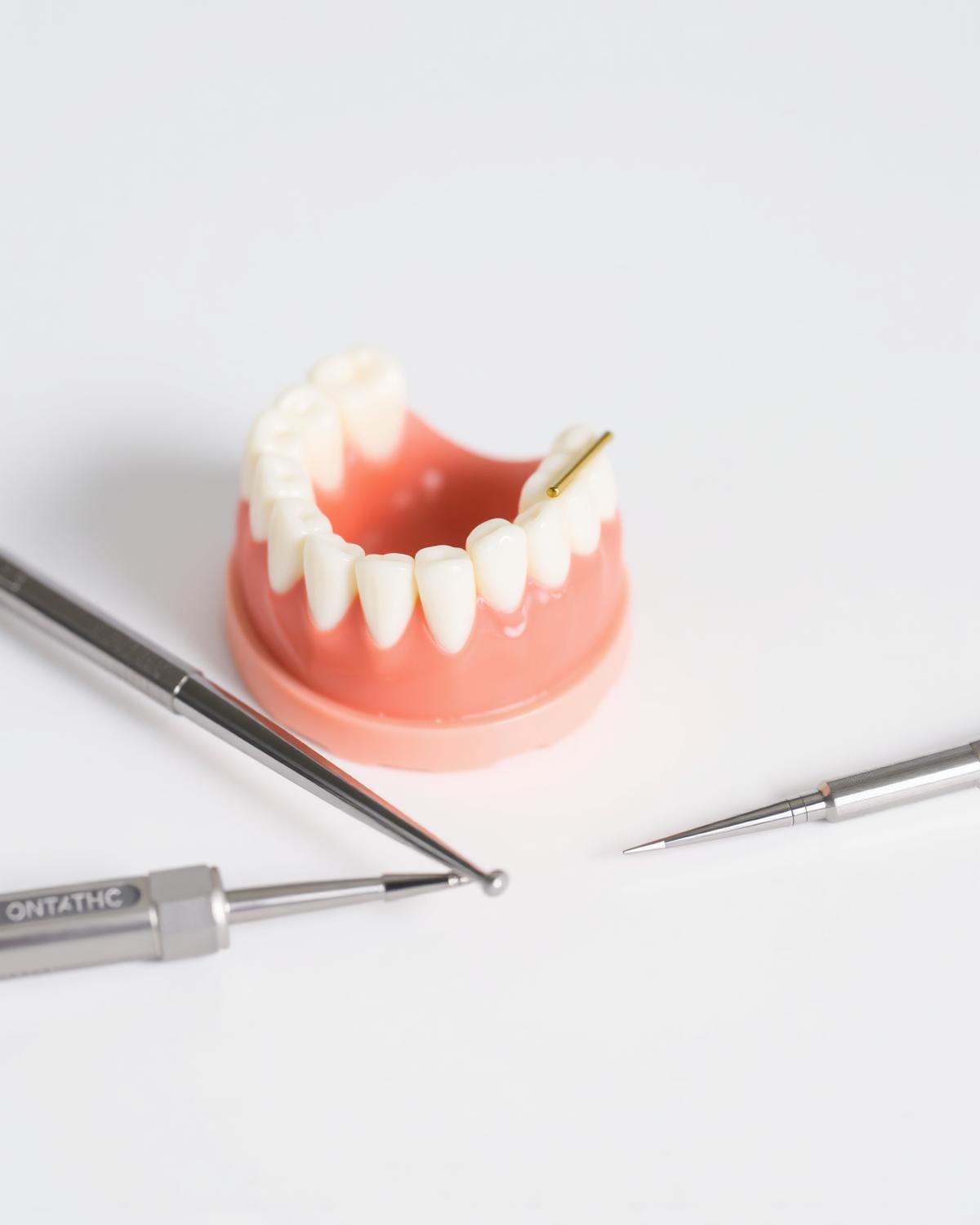 Dental crown and tooth model with instruments — Dr. Marc Habib